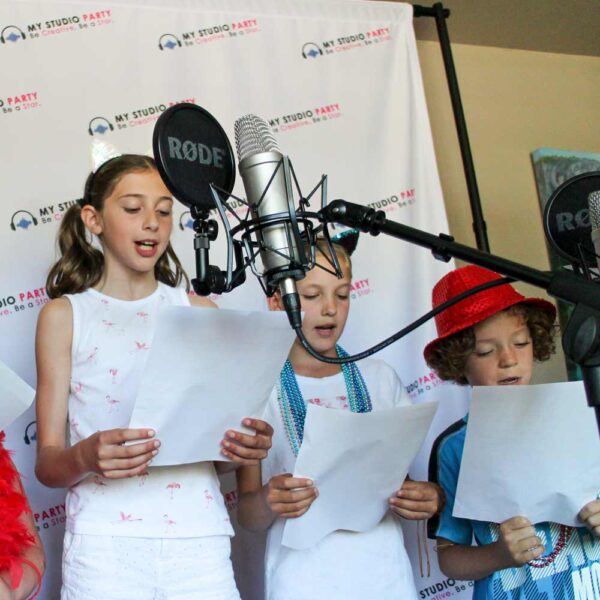 Kids recording a song with a microphone with My Studio Party