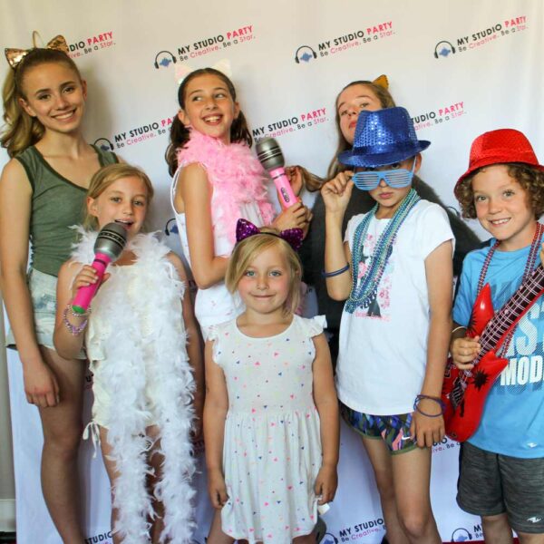 Kids posing on red carpet at Popstar birthday party with My Studio Party
