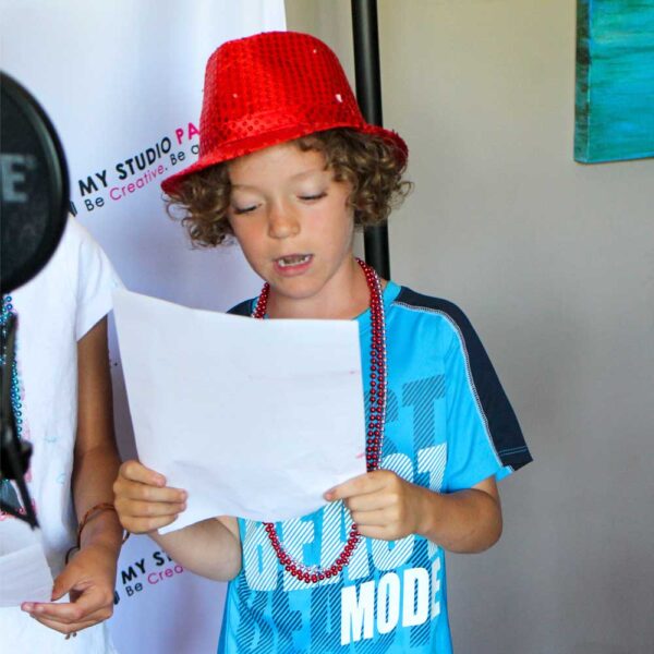 Little boy at My Studio Party singing and recording
