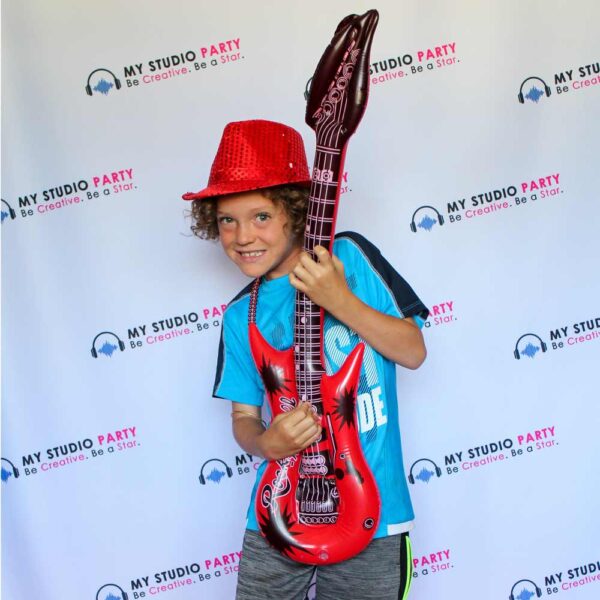 Young boy with red accessories and guitar at My Studio Party photoshoot