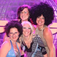 Women dressed up and posing at Disco Night Theme Night Party with organijeu and My Studio Party