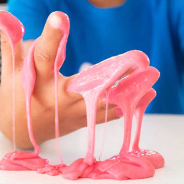 Gooey pink slime on a hand