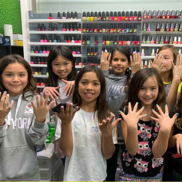 young girl group showing off their nails