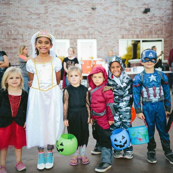kids wearing various halloween costumes
