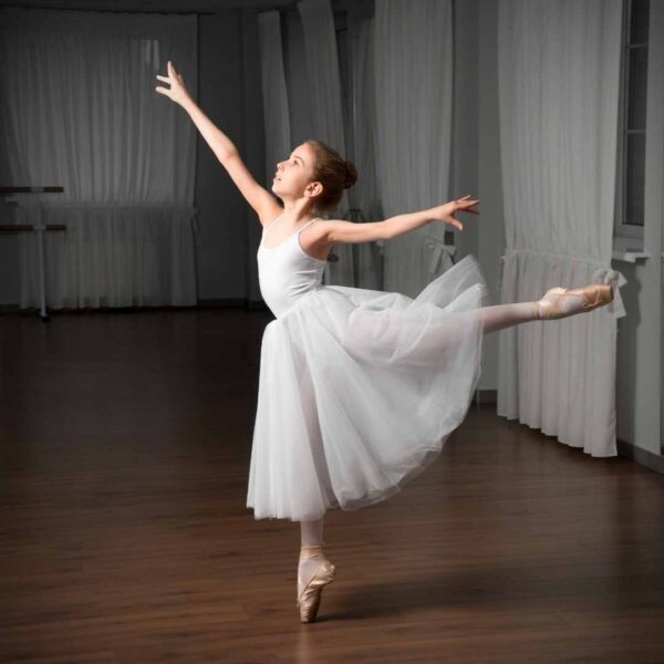 young girl ballet dancing with white tutu