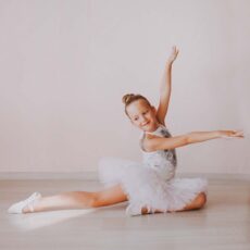 young girl ballet posing with white short tutu