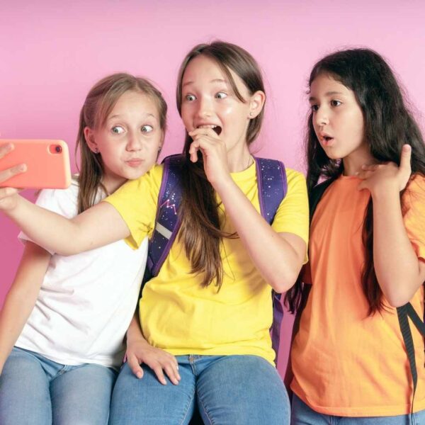 Young girls laughing and taking a selfie